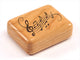 Top View of a 2" Flat Narrow Cherry with laser engraved image of Music Notes