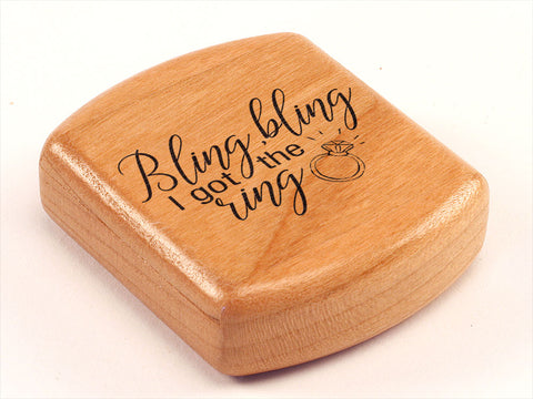 Top View of a 2" Flat Wide Cherry with laser engraved image of Bling Bling I Got the Ring